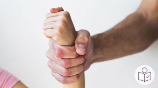 Das Bild zeigt die Faust von einem Mann. Die Faust hält das Hand·gelenk von einem Kind fest. Rechts das SWR Logo für Leichte Sprache. 