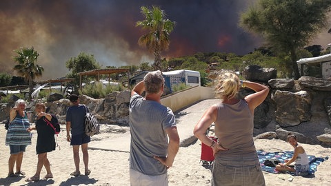Touristen beobachten einen Waldbrand 2017 an der Côte d'Azur