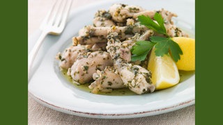 Froschschenkel mit viel Kräuter in Butter und Knoblauch. Symbolfoto.