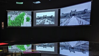 Projektionen zeigen in der Ausstellung, wie Fotos vor hundert Jahren retuschiert wurden
