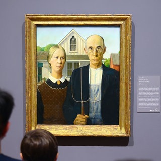 Visitors contemplate 'American Gothic' painting by Grant Wood at Art Institute of Chicago in Chicago, Illinois, United States. File photo.