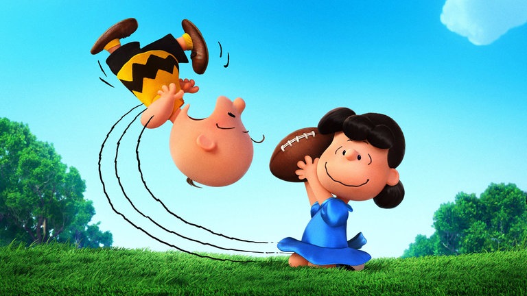 Die Peanuts (Szene aus Film-Serie): Lucy entreißt Charlie Brown einen Rugby-Ball - Charlie stürzt