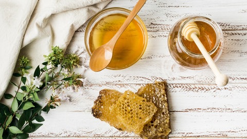 Honiggläser und Wabe: Krebspatienten sollten möglichst wenig Industriezucker zu sich nehmen und bei Süßhunger lieber zu Marmelade oder Honig greifen. 