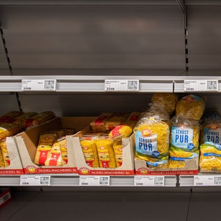 Ein fast leeres Regal mit Nudeln in einem Supermarkt.