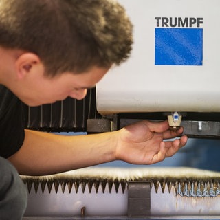 Ein Mitarbeiter baut an einem Laser der Firma Trumpf.