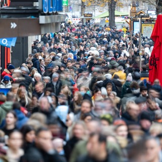 Symbolbild: Menschen laufen in Stuttgart die Königstraße entlang. Die Aufnahme ist mit Langzeitbelichtung entstanden.