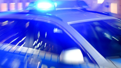 Ein Streifenwagen der Polizei steht mit eingeschaltetem Blaulicht auf der Straße. (Symbolbild)