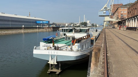 Ein Schiff steht am Rheinhafen in Karlsruhe. Dort ist der Wasserstand aktuell sehr niedrig.