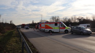 An einer Unfallstelle auf der A6 bei Brühl stehen mehrere Krankenwagen. 