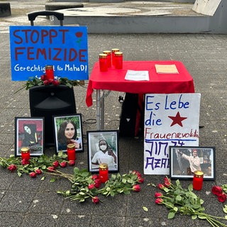 Kerzen, Blumen und Transparente bei der Gedenkkundgebung für die 31-jährige, getötete Pflegekraft in Stuttgart.