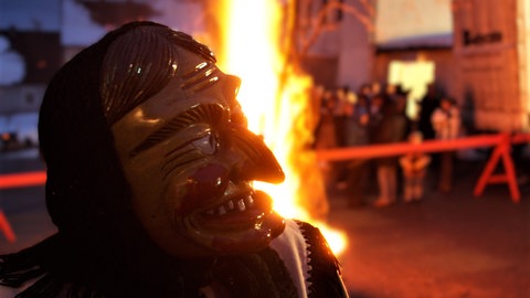 Eine Fasnetshexe aus Obernheim (Zollernalbkreis) vor dem Hexenfeuer. Sie steht im Mittelpunkt des"Hexenprozesses". 