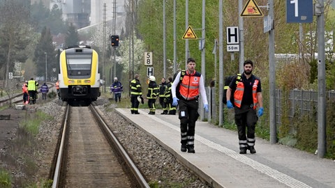 In der Ferne eine Regionalbahn, Helfer auf dem Bahnsteig: An einem Bahnübergang in Blaustein hat ein Zug einen 24-jährigen Mann erfasst. Er starb im Krankenhaus.