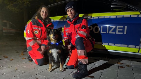 Rettungshündin Jules ist fünf Jahre alt und ein Australian Shepherd. Hier ist sie nach dem Einsatz mit Truppfrau Michaela Weidenlener (links) und Rettungshundeführerin Katrin Scherraus zu sehen. 
