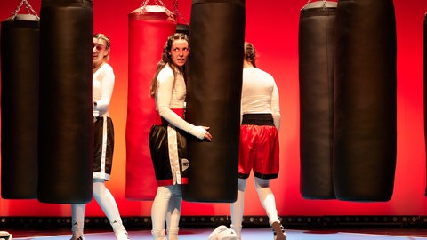 Drei Schauspielerinnen auf der Bühne in "Stehaufmädchen" - Rola El-Halabis wahre Geschichte auf der Bühne des Podiums