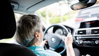 Eine über 90-jährige Frau sitzt hinter dem Lenkrad eines Autos. Ältere Menschen am Steuer eines Autos sind immer häufiger an Verkehrsunfällen beteiligt. (Symbolbild)