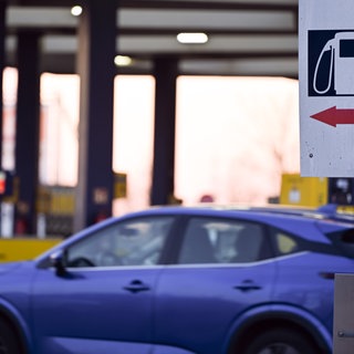 Eine Tafel mit Piktogrammen an einer Tankstelle. Wegen des Irankriegs steigen die Ölpreise deutlich. Einige Unternehmen haben Mitarbeitende in der Region und sorgen vor.