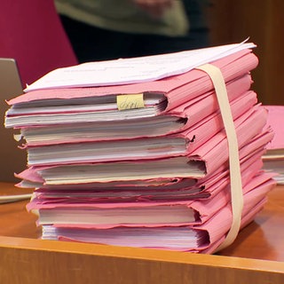 Gesammelte Akten auf Schreibtisch im Gerichtssaal
