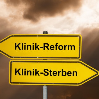 Ein Wegweiser, der Pfeil zeigt nach links zur Klinikreform, nach rechts zum Klinik-Sterben