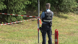 Ein Polizist in der Nähe des Ortes, wo die mutmaßlich getötete Frau in ihrem Wagen gefunden wurde. Die 29-Jährige aus Wirft starb an mehreren Stichverletzungen.