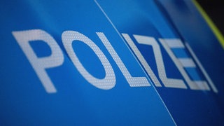 Das Wort Polizei ist auf der Karosserie eines Polizeifahrzeugs zu sehen. Symbolbild.