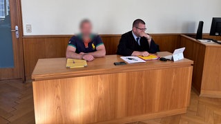 Der 46-jährige mutmaßliche Fluchthelfer (links) mit seinem Verteidiger zum Prozess vor dem Landgericht in Landau.