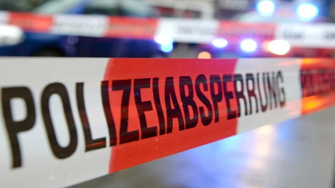 Absperrband mit der Aufschrift "Polizeiabsperrung". In Wiesbaden hat ein Bankräuber eine Bank überfallen und ist mit einem Klapprad geflohen