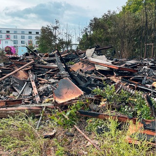 Am Tag nach dem Brand liegt verbranntes Material an der Einsatzstelle an der Mombacher Straße in Mainz. 