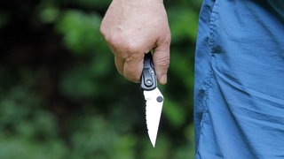 Ein Mann mit einem Messer in der Hand: Zwei Männer wurden in Mainz mit Messer und Pfefferspray verletzt