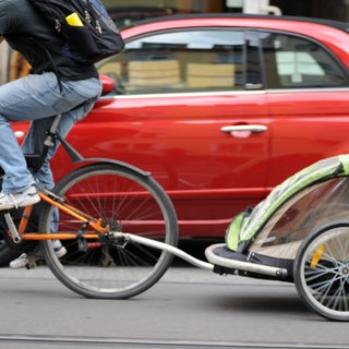 Ein Fahrrad mit Kinderanhänger - weil er nicht an ihm vorbeikam, hat in Mainz ein Autofahrer auf einen Radfahrer eingeschlagen (Symbolbild).