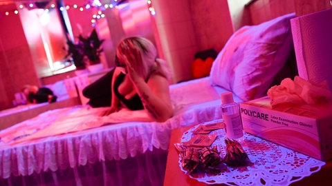 Eine Prostituierte liegt auf einem Bett