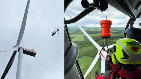 Nach einem Brand in einem Windrad bei Desloch wird ein Höhenretter abgeseilt.
