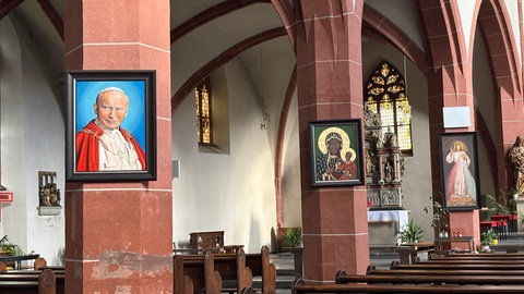 Das Bild Papst Johannes Pauls II. zeigt, dass die polnisch-sprachige Gemeinde oft in St. Antonius zu Gast ist. Auch die syrisch-katholische Gemeinde hält hier Messen ab.