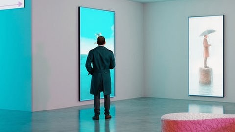 Ein Mensch liegt in einem Kornfeld, man sieht nur ein Bein und die ausgestreckten Arme mit einem Magazin Menschen ein Bein und einen Arm mit einem Magazin in der HandAus einem Kornfeld unter wolkenverhangenem Himmer mit Bergen am Horizont sieht man 