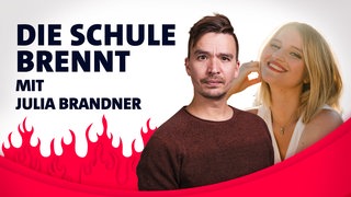Julia Brandner und Bob Blume vor Flammen