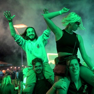 Junge Menschen tanzen beim Shelterwood Festival zu heißen Beats auf der Rheinpromenade in Emmerich: Immer weniger Menschen gehen abends in Clubs und Kneipen. Sie organisieren Raves, pilgern zu DJ-Gigs auf der grünen Wiese oder treffen sich zu Hause. 