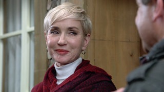 Frau Dr. Siegel-Brack steht lächelnd vor dem Löwen