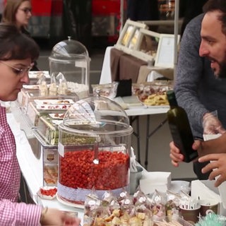 Eine Frau probiert bei einem Stand auf einem Street-Food-Festival